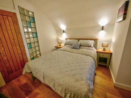 霍姆弗斯Pell Dell Apartment的一间卧室配有一张床和两个带灯的床头柜