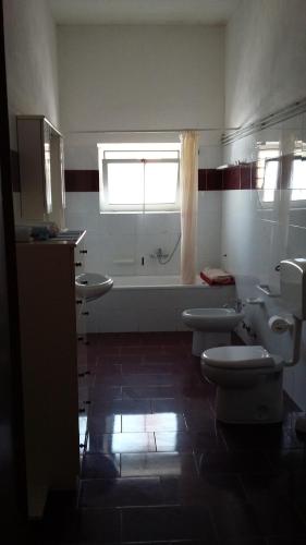 萨尔维villetta Belgiorno的一间带3个卫生间、浴缸和水槽的浴室