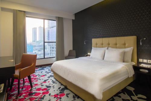 坦林雅加达自由酒店客房内的一张或多张床位