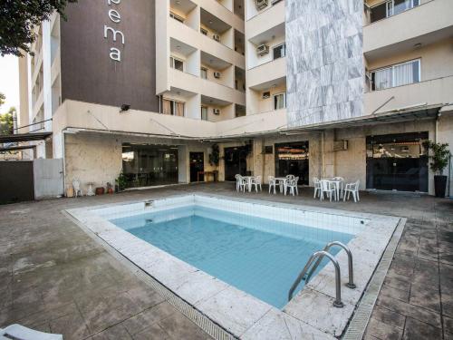 圣若泽杜斯坎普斯OYO Urupema Hotel, São Paulo的大楼前的游泳池