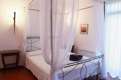 阿祖罗港Elba Vip的卧室配有白色天蓬床和窗户