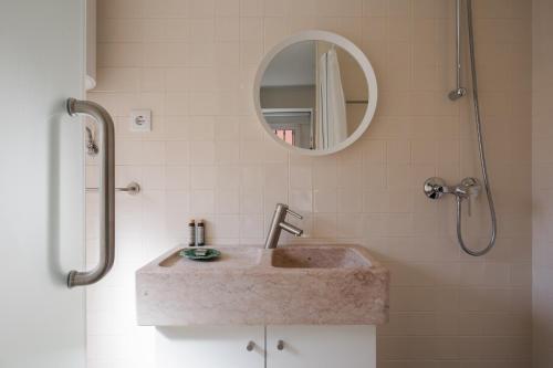 里斯本Typical and Brand New T.M. Flat的一间带水槽和镜子的浴室
