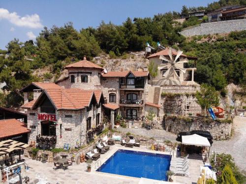 AğaçlıThe Stone Castle Boutique Hotel的享有带游泳池的房屋的空中景致