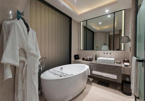 上海上海中星铂尔曼大酒店的一间带浴缸和大镜子的浴室