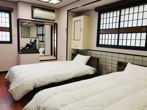 Guesthouse & Hotel RA Kagoshima客房内的一张或多张床位