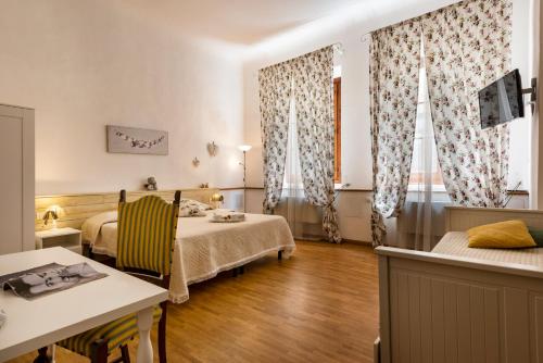 佛罗伦萨圣雷米希奥住宿加早餐旅馆的一间设有两张床和一张桌子及椅子的房间