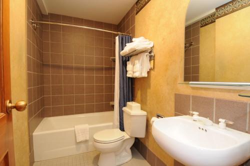大天空市Shoshone Condos at Big Sky Resort的浴室配有盥洗盆、卫生间和浴缸。