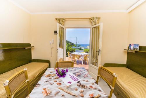 卡波利韦里Residential Hotel Villaggio Innamorata的一间设有桌子的海景用餐室