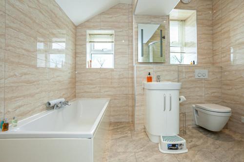 凯西克Carlton 2 a large Keswick appt with parking的带浴缸、卫生间和盥洗盆的浴室