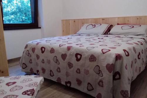 巴塞尔加·迪·皮纳Casa vacanze Insieme的一张床上,床上有一条毯子,上面有心