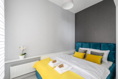 华沙Gama的一间卧室配有黄色和蓝色的床