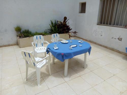 达喀尔Chez MAX et KHADY的一张桌子和椅子,上面有蓝色的桌布