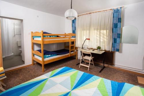 波斯托伊纳ANA.k宾馆的一间卧室配有双层床、一张桌子和一张床。