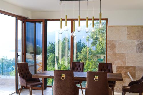 斯韦蒂·斯特凡Villa Horus的一间带木桌和椅子的用餐室