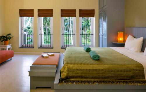 拉迈棕榈景观别墅的一间卧室配有一张带窗户的大床