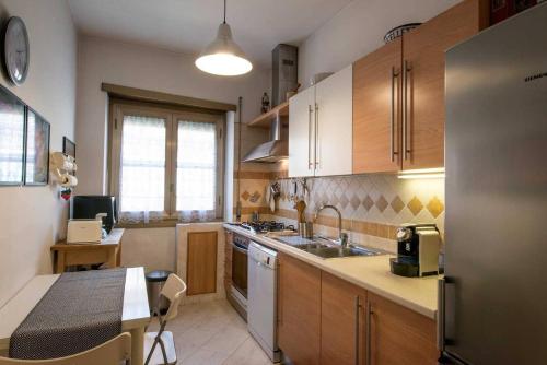 罗马Eucalyptus Resort - Roma San Paolo -的厨房配有木制橱柜、水槽和桌子