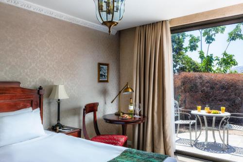 提比里亚Europa 1917的酒店客房设有一张床和一个带桌子的庭院。