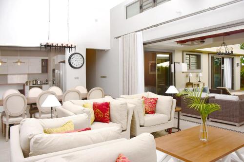 巴拉克拉瓦Luxury Villas at Royal Park的客厅配有白色沙发和时钟