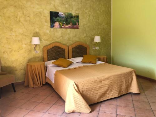 利扎诺-因贝尔韦代雷佛达乔酒店的一间卧室设有一张黄色墙壁的大床