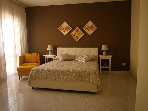 基耶蒂B&B Abruzzo Mare e Monti的一间卧室配有一张床和一张黄色椅子