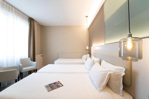 米兰米兰城堡酒店的酒店客房设有两张床和窗户。