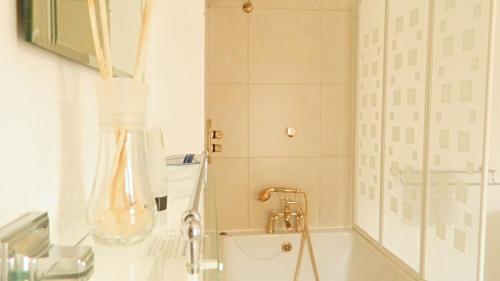 沃里克沃里克金斯赫德酒店的浴室配有盥洗盆和带镜子的淋浴