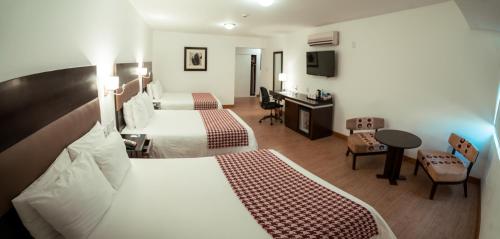 齐克拉约奇克拉约温德姆太阳海岸酒店的酒店客房配有两张床和一张书桌