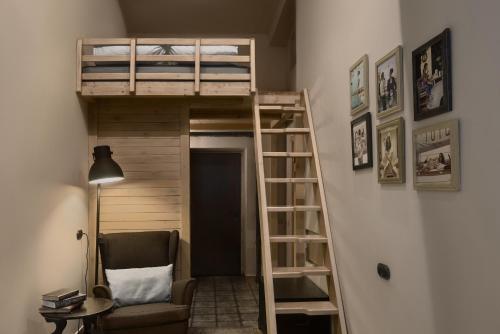 鄂木斯克砖墙宾馆的带高架床和椅子的客房