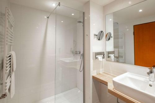 利普施塔特利普施塔特品质酒店的带淋浴和盥洗盆的白色浴室