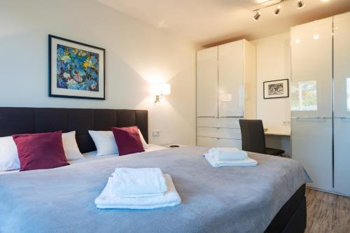加兹尤瑟多姆Terrassenwohnung "Haffparadies" - Oase am Haff的一间卧室配有一张大床和毛巾