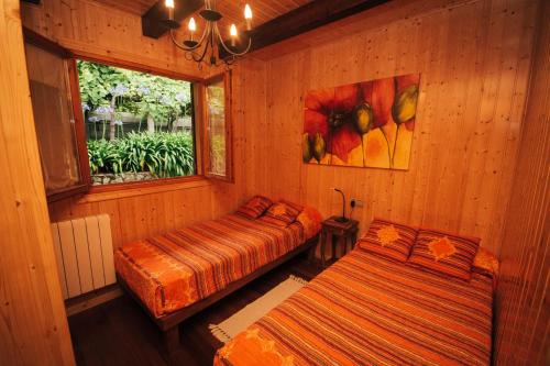 布埃乌Lar de Lagos的一间卧室设有两张床和窗户。