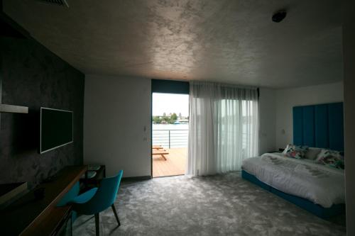 贝尔格莱德FLOW的一间卧室配有一张床、一张书桌和一个窗户。