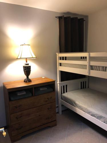 布鲁克林Brooklyn's Finest - Cozy 2 Bedroom的一间卧室配有两张双层床和梳妆台上的灯。