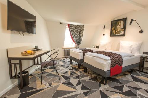 利耶帕亚Art Hotel Roma的配有一张床和一张书桌的酒店客房