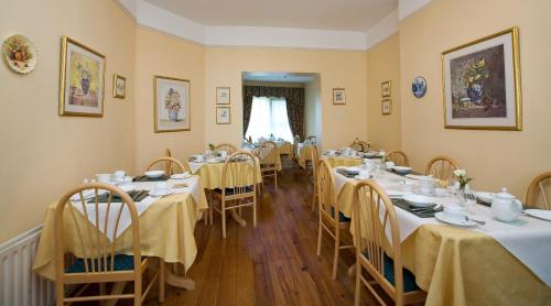 戈尔韦格里芬旅馆的用餐室设有桌椅和黄色的墙壁