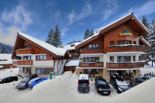 多纳瓦利嘉德尼雅别墅的雪地里停有车辆的滑雪小屋