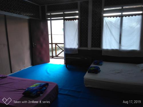 Rumah Sakinah客房内的一张或多张床位