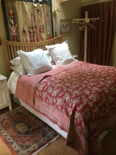 多切斯特The old forge bed and breakfast的一张带红色毯子和白色枕头的床