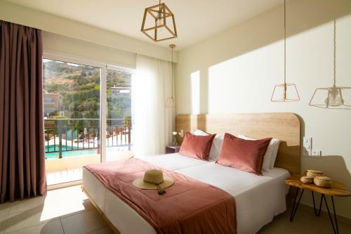 斯塔里斯彩虹公寓酒店的一间卧室设有一张床和一个大窗户