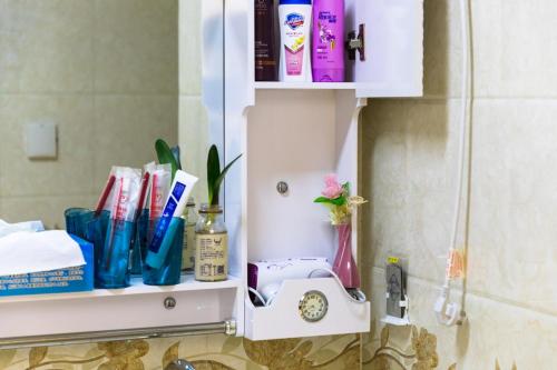 西宁【路客】西宁市城西区·万达广场·路客精品公寓·00151720的浴室架上备有牙刷和其他物品