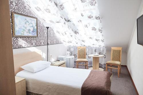 提特拉诺伊欧斯比涅雅克酒店客房内的一张或多张床位