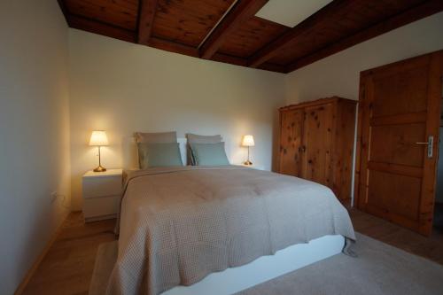 维也纳Vacationhome in the vineyards的一间卧室配有一张大床和两盏灯