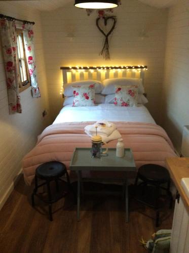 兰戈伦Llangollen Shepherds Huts的一间卧室配有一张带桌椅的床