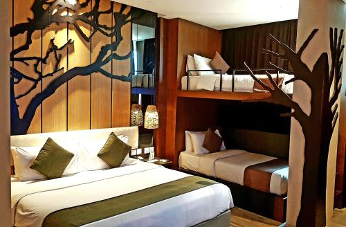 巴淡岛中心艾斯卡酒店的一间卧室配有两张床和一棵树壁画