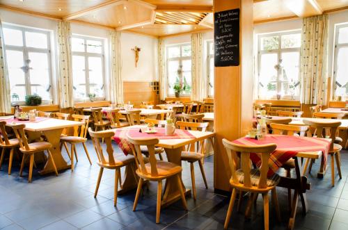 罗丁Wallfahrts-Gaststätte Heilbrünnl的餐厅设有桌椅和窗户。