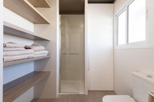 圣巴托洛梅ASARA PLAYA 2的一间带玻璃淋浴和白色毛巾的浴室