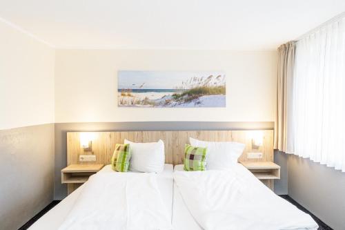 库克斯港Gästehaus Alexandra的一间卧室配有两张床和两张桌子