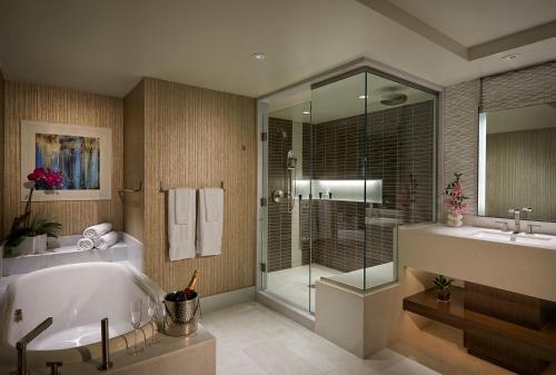 坦帕塞米诺尔硬岩酒店和坦帕赌场的带浴缸和玻璃淋浴间的浴室。