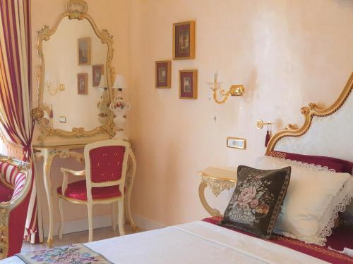 维罗纳FD Luxury rooms的一间卧室配有一张床、镜子和椅子