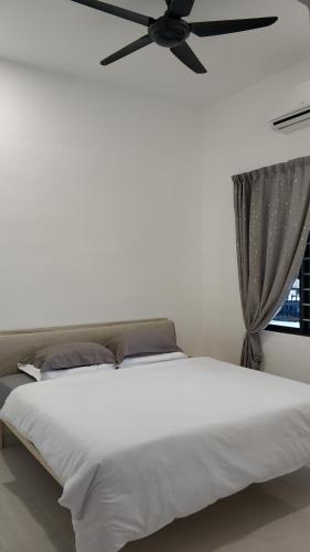 丰盛港Mersing little homestay with free WIFI的卧室配有白色的床和吊扇